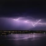 lightning over body of water during night time